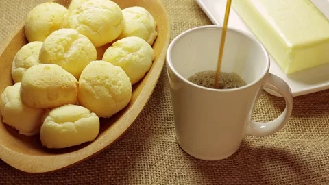 Authentic Brazilian cheese bread served with butter on a rustic burlap Stock Footage 337274665