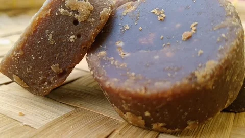 Authentic Brown Sugar and Jaggery Chunks on Detailed Bamboo Mat Video stock 341456204