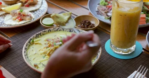 Authentic Burmese coconut noodle soup with fresh herbs on table. Asian Vídeos de archivo 311998323