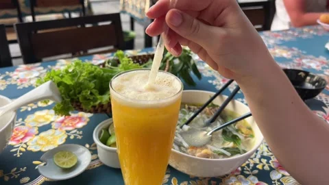 Authentic Burmese coconut noodle soup with fresh herbs on table. Asian cuisine Stock Footage 317703350