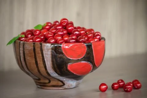 Authentic ceramic bowl with cherry. Stock Photos