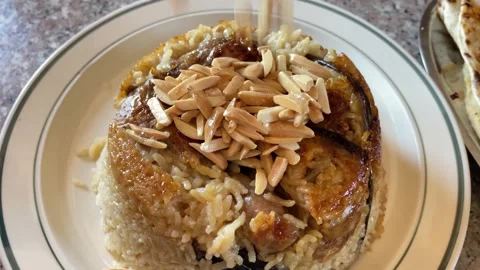 Authentic Chicken Maqluba Garnished with Toasted Almonds Stock Footage 345522053