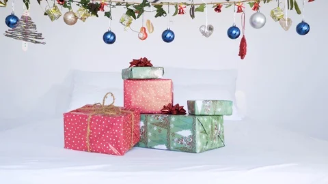 Authentic Chrismas presents on top of bed with suspend decoration. Stock Footage 102657827