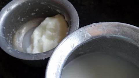 Authentic Churned Dairy Fat in Vintage Aluminum Cookware reflecting age-old Sout Stock Footage 345302593