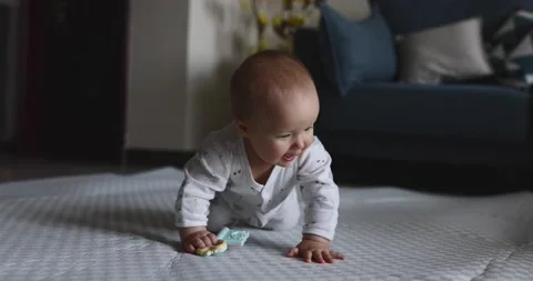 Authentic close up Cute Caucasian Baby Girl six months old learning crawl on Stock Footage 150285324