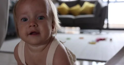 Authentic close up Cute Caucasian Baby Girl 1 year old Playing on floor in Stock Footage 157625313
