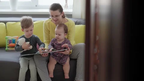 Authentic close up cute neo caucasian spectacled mom with 2 children boy and Stock Footage 149358196