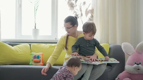 Authentic close up cute neo caucasian spectacled mom with 2 children boy and Stock Footage 150464033