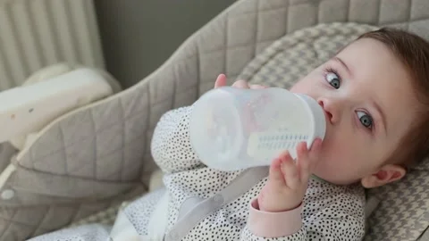 Authentic Close Up Footage of a Newborn Drinking Milk from Baby Bottle while Video stock 159602949