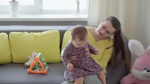 Authentic close up shot of young caucasian mother keep in arms, caressing song Stock Footage 149441814