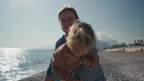 Authentic close up shot of an young mother is keeping on her arms and playing Stock Footage 244628125