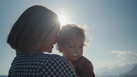 Authentic close up shot of an young mother is keeping on her arms and playing Stock Footage 244628195