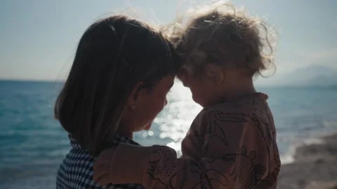 Authentic close up shot of an young mother is keeping on her arms and playing Stock Footage 244628232