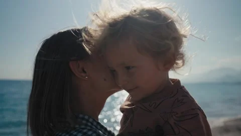 Authentic close up shot of an young mother is keeping on her arms and playing Stock Footage 244628251