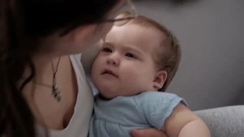 Authentic close up shot of young neo caucasian mother keeping in arms and Video stock 148445076