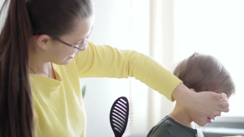 Authentic close up shot of young neo caucasian cute mother take care combs Stock Footage 149374787