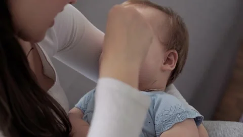 Authentic close up shot of young neo caucasian mother keeping in arms and Stock Footage 149377446