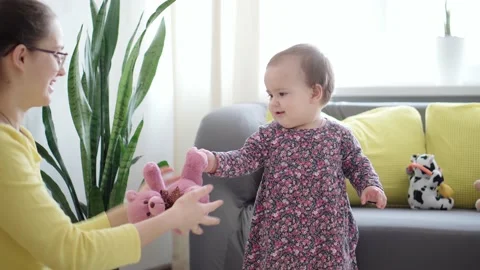 Authentic close up shot of young neo caucasian mom play with soft toys teddy Stock-Footage 149441648