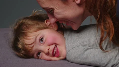 Authentic close up shot of young neo mother is playing with her baby in a Stock Footage 234653934
