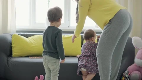 Authentic close up of young neo caucasian mom play with two little kids infant Stock Footage 150282313