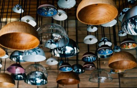 Authentic creative lamps from the plates in the interior of the cafe Stock Photos