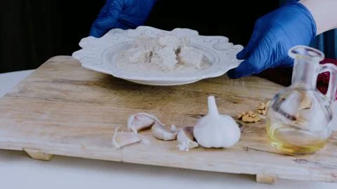 Authentic culinary presentation: mixing spices into creamy walnut sauce 스톡 사진