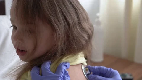 Authentic cute caucasian cute young woman nurse or doctor pediatrician examine Stock Footage 151762918