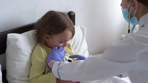 Authentic cute caucasian cute young woman nurse or doctor pediatrician examine Video stock 151864856