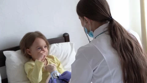 Authentic cute caucasian cute young woman nurse or doctor pediatrician examine Stock Footage 152107817