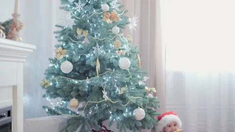 Authentic cute happy Joy chubby infant girl wearing santa hat and red dress Stock Footage 152940974