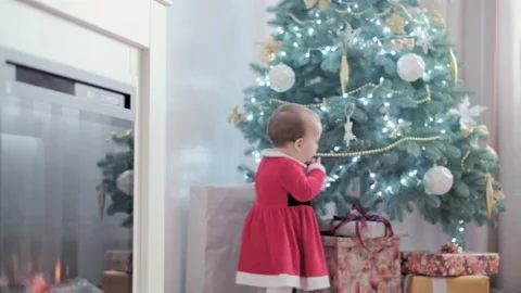 Authentic cute happy Joy chubby infant girl wearing santa hat and red dress Stock Footage 153882049