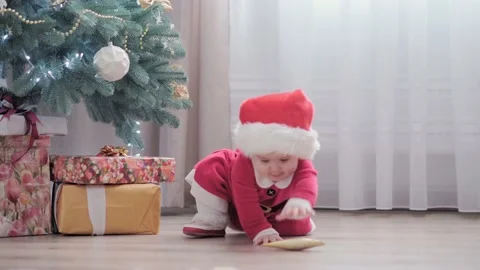 Authentic cute happy Joy chubby infant girl wearing santa hat and red dress Stock Footage 154780253