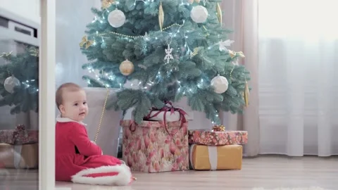 Authentic cute happy Joy chubby infant girl wearing santa hat and red dress Stock-Footage 155866428