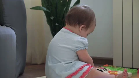 Authentic cute infant chubby child girl with snot under nose make color toy Stock Footage 150178059