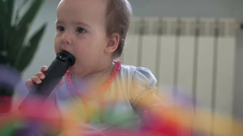 Authentic cute infant chubby child girl with snot under nose make color toy Stock Footage 150664093
