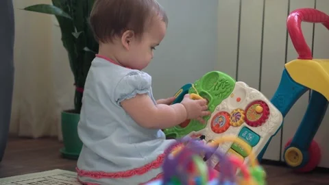 Authentic cute infant chubby child girl with snot under nose make color toy Stock Footage 150762118