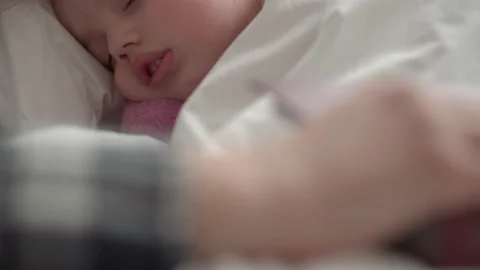 Authentic cute young mom fell asleep read fairy tale from book to baby before Stock Footage 153882074