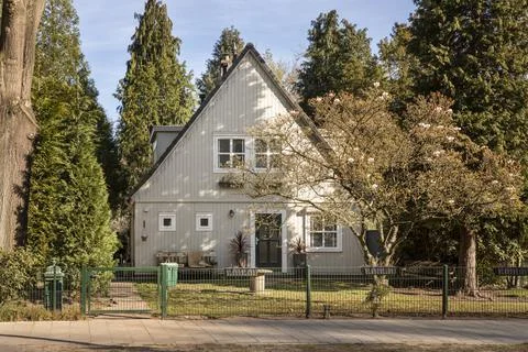 An authentic Dutch house in Eindhoven surrounded by trees with blossoms 스톡 사진