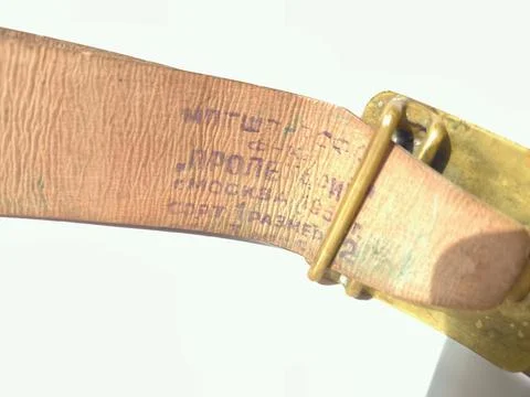 Authentic factory stamp on the inner side of vintage leather belt. Stockfoto's