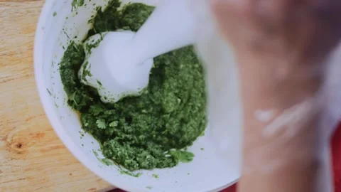 Authentic food texture study: combining spices for green adjika Stock Footage 342200674