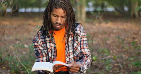 Authentic Footage of Smart Young Black Man Reading Stock Footage 142231696