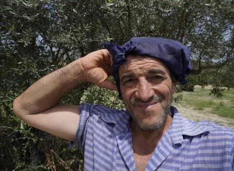 An authentic, full-length portrait of an elderly farmer. Fotos de archivo