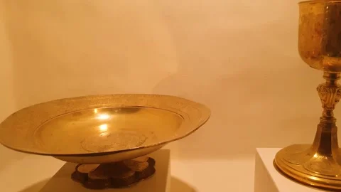 An authentic gold plate, platter, and cup for eating. Antique gold bowl, plate Stock Footage 346766066