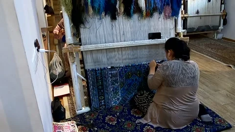 Authentic handmade carpet weaving process in a workshop in Bukhara Stock Footage 335573508