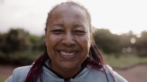 Authentic headshot of happy senior African woman looking at camera outdoor Stock Footage 271306341