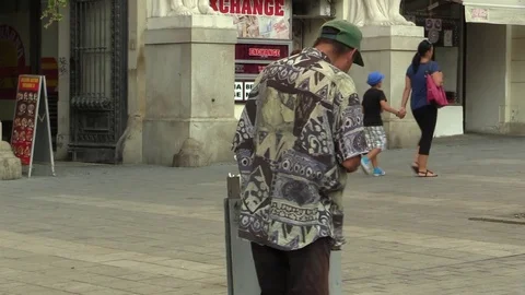 Authentic homeless poor man looking and eats food from the trash bin Stock Footage 85302249