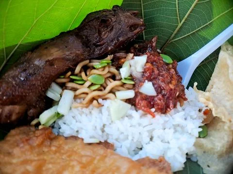 Authentic Indonesian dish featuring satay skewers, rice, and spicy sambal, .. Stock Photos