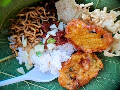 Authentic Indonesian dish featuring satay skewers, rice, and spicy sambal, .. Stock Photos
