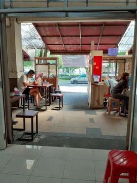 Authentic Indonesian Open-Air Eatery with Local Customers Dining Stock Photos