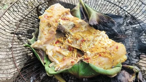 Authentic Indonesian Tilapia Fish Head Grilled Over Coconut Husk Fire Stock Footage 328383329